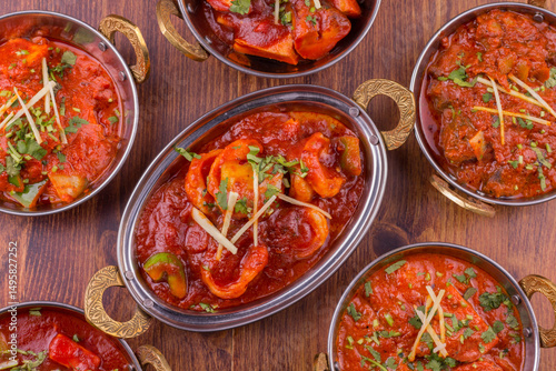 Composition with indian dishes: samosa, pakora, palak paneer, jalfrezi, thukpa and naan bread