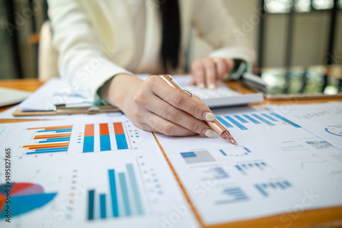 lot of documents are prepared on table for the meeting, including annual financial statements and documents that compile company profit statistics. lot of documents are placed on the desk in office.