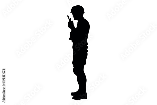 Silhouette of a soldier in uniform wearing a helmet and holding a radio communication device