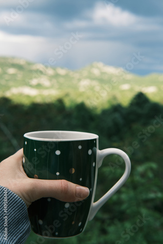 Morning coffee against the backdrop of an incredible peaceful mountain landscape