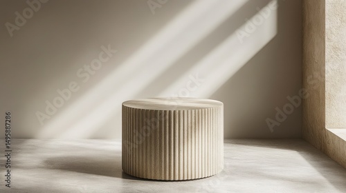 Cylinder stone podium featuring fluted detailing stands serenely amid soft sunlight shadows, enhancing architectural charm