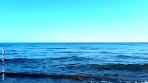 Wallpaper Mural Calm ocean waves under a clear blue sky creating a tranquil seascape with a distant horizon, offering a serene and peaceful view of nature's beauty Torontodigital.ca