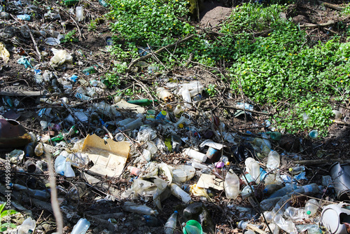 Environmental pollution caused by plastic waste and litter in a natural environment.
