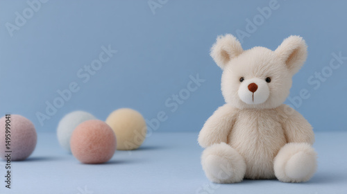 White teddy bear and pastel Easter eggs on blue background. Cute plush toy for baby shower, nursery decor, or children's gift. Soft and cozy childhood concept.