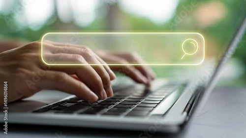 Navigating the Digital Frontier: A close-up view of hands typing on a laptop keyboard, with a glowing search bar.
