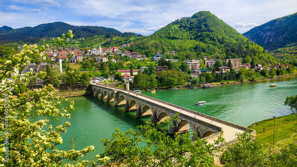 Obraz premium Ancient stone bridge on the Drina River. The famous historical bridge on the Drina River, built in 1571. by Mehmed Pasa Sokolovic in the city of Visegrad, Bosnia and Herzegovina.