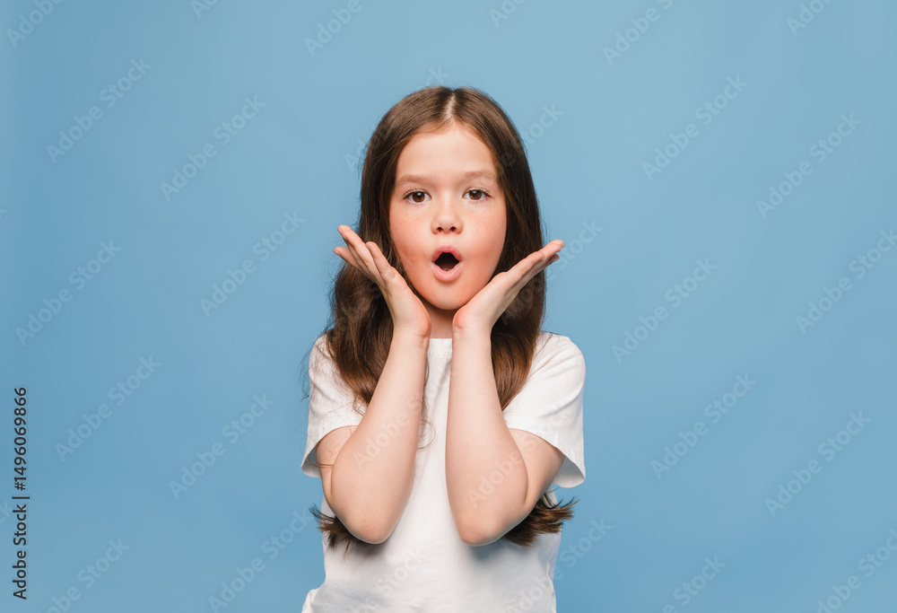 little girl holding hands near face and wondering on blue background little girl holding hands near face and wondering on blue background