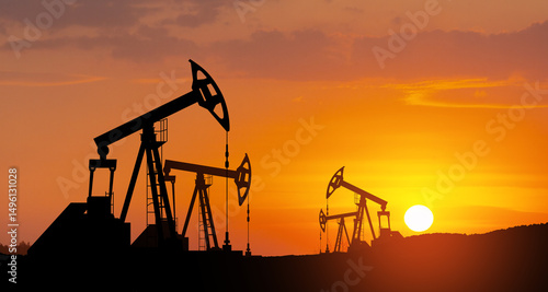 Oil drilling derricks at desert oilfield. The change in oil prices caused by the war. Oil price cap concept.