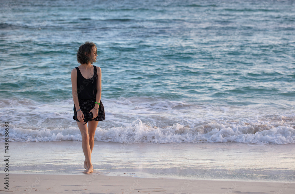 pretty young woman is walking by the sea pretty young woman is walking by the sea