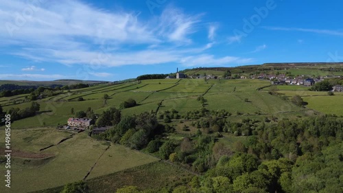 scenic aerial drone shot of west yorkshire pennine landscape with the village of old town near hebden bridge surrounded by calderdale scenery