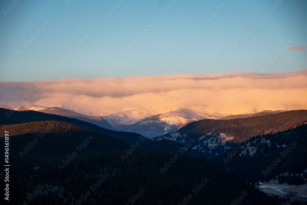 Fototapeta premium clouds coming in low over the Rocky Mountains