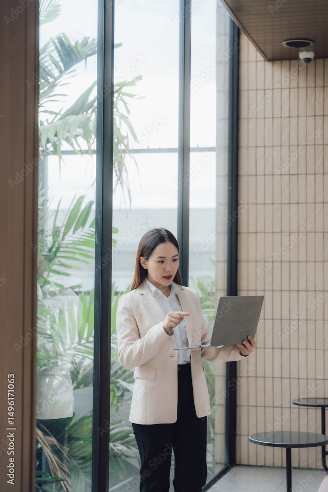 Fototapeta premium Confident Asian Businesswoman with Laptop