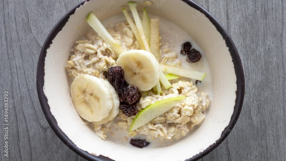 Rotating Bowl of Overnight Oats with Bananas, Apples and Blueberries Rotating Bowl of Overnight Oats with Bananas, Apples and Blueberries