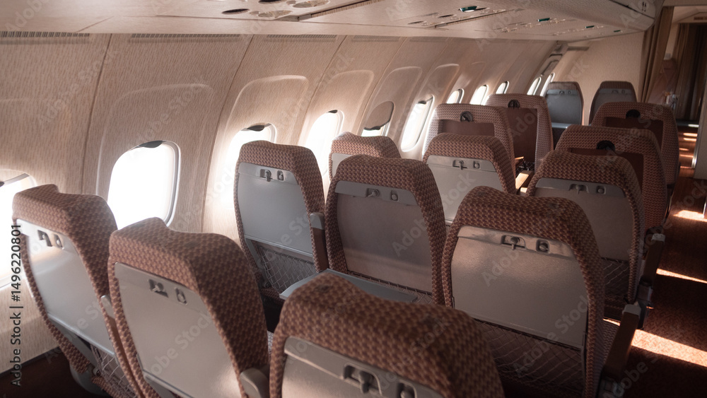 Fototapeta premium Empty passenger seats line the aisle of a Soviet-era airplane, featuring a vintage design that reflects the travel aesthetics of the USSR period.