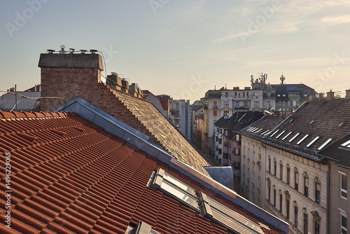 Canvas Print Tiled Building Roofs Over a City Street