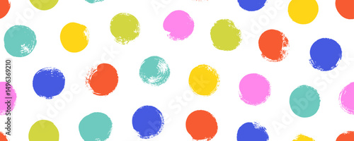 Colorful seamless polka dot pattern. Brush drawn rough multi colored circles. Funky abstract simple background with dots.