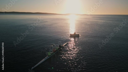 Wallpaper Mural Cinematic drone shot A Rowing Crew Moves In Perfect Unison Through Halifax Bay At Sunrise. Aerial View Shows Elegant Water Movement As Oars Cut Through The Dawn Reflection. Torontodigital.ca