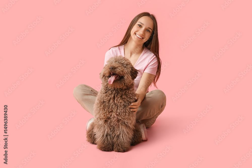 Young woman with brown Poodle dog sitting on pink background Young woman with brown Poodle dog sitting on pink background