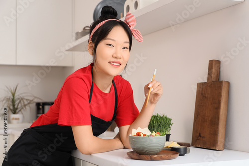 Young Asian woman with tast...