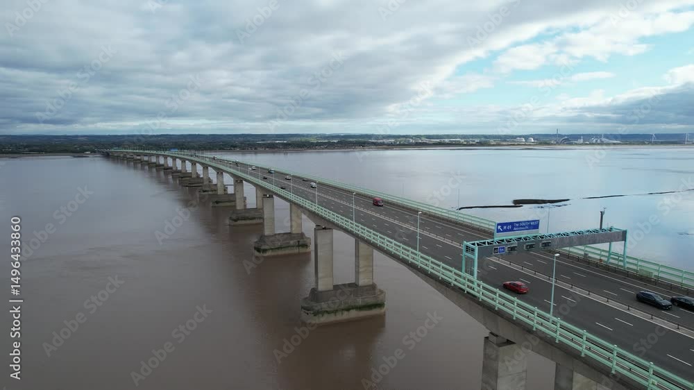 Amazing transport structure. Fly along long pillar highway bridge over wide Severn river estuary. Prince of Wales Bridge, Wales, UK Amazing transport structure. Fly along long pillar highway bridge over wide Severn river estuary. Prince of Wales Bridge, Wales, UK