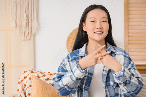 Mute Asian woman using sign...