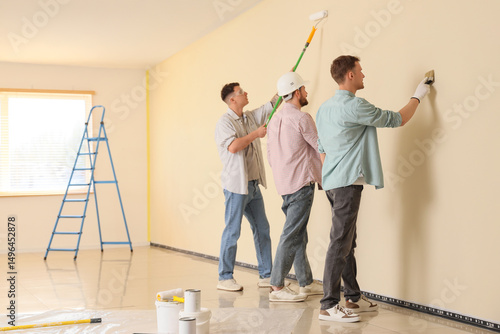 Group of young men painting...