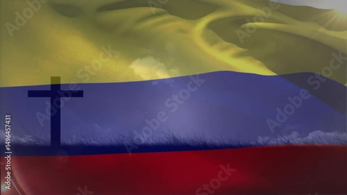 Wind blowing causing Colombian flag rippling while sun rays lighting cross silhouette for pride