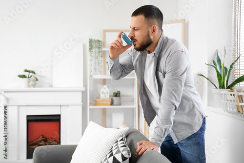 Young man using inhaler at ...