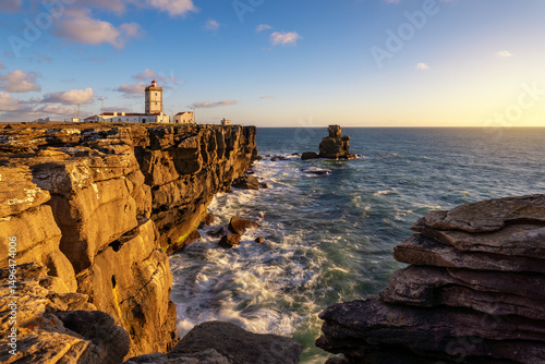 Leuchtturm auf den Klippen bei Sonnenuntergang