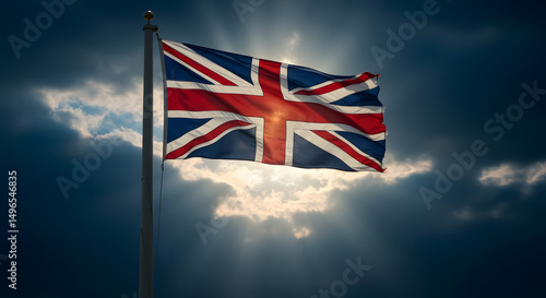 flag of united kingdom.Dramatic UK Union Jack Flag with Sun Rays Breaking Through Dark Clouds.