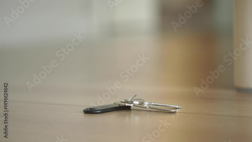 Keys on the floor near a wooden table, lost key concept 