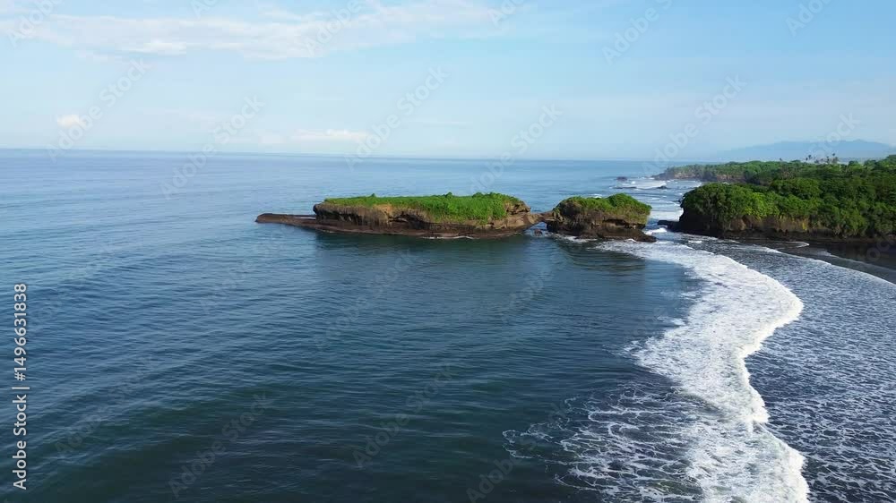 Aerial view of Kelecung Beach in Tabanan, Bali, captured on a misty morning. The scene blends black sand shores with lush green rice fields, partially veiled by soft morning fog. Aerial view of Kelecung Beach in Tabanan, Bali, captured on a misty morning. The scene blends black sand shores with lush green rice fields, partially veiled by soft morning fog.