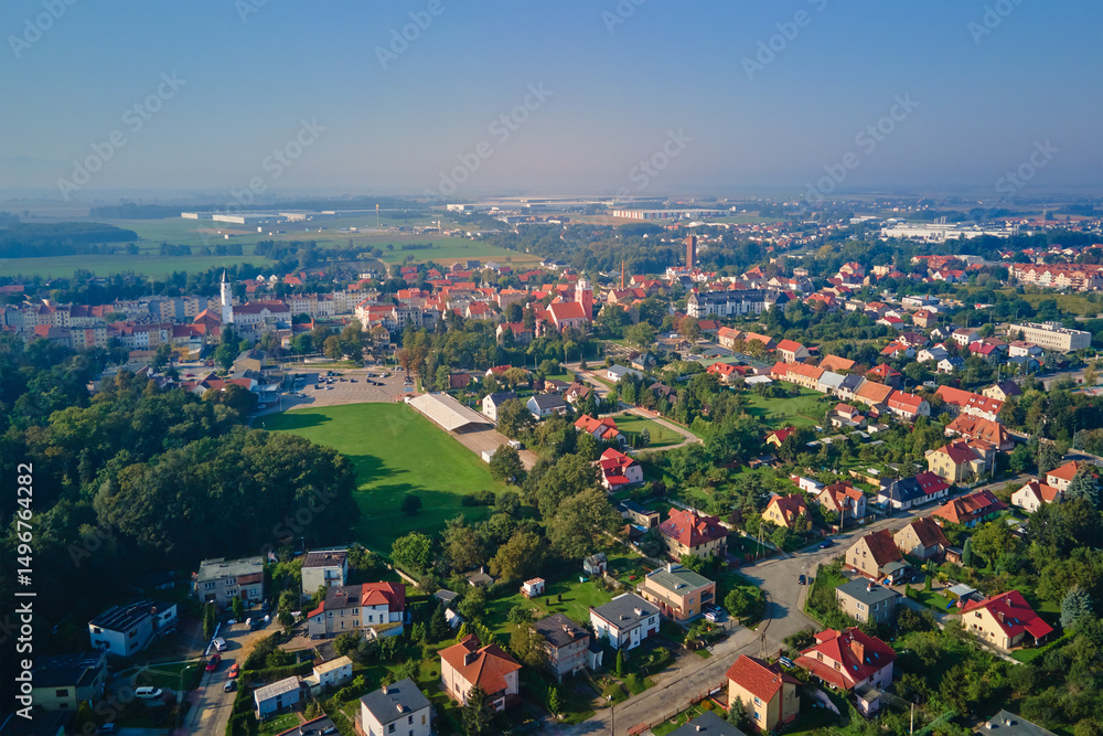 Fototapeta premium Aerial view of European small town. Drone view of urban landscape with residential building, green parks and city streets