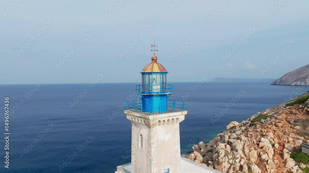 Cape Tainaron Lighthouse stands atop rocky hill overlooking sea, from drone at distance Cape Tainaron Lighthouse stands atop rocky hill overlooking sea, from drone at distance