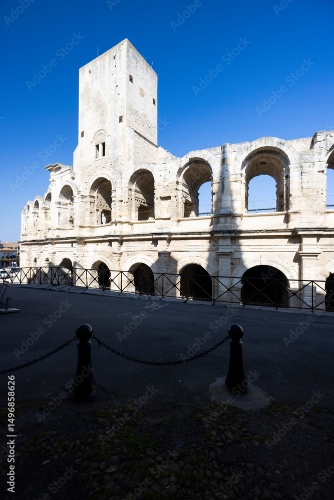 Fototapeta premium Arles Amphitheater standing tall under blue sky in Provence, France