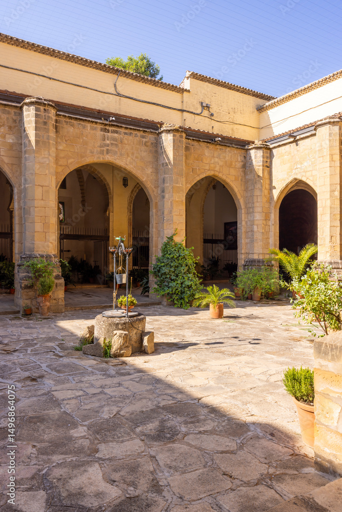 Fototapeta premium Cloister with arches and well in the Palace of Jabalquinto in Baeza, Spain