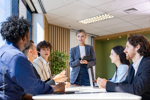 Caucasian woman sale manager is showing annual report to her colleagues in executive meeting for next year plan with market share increase for global business and investment