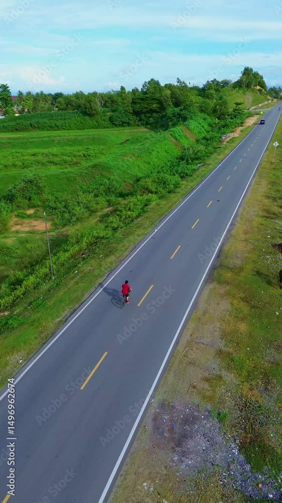 Aerial View of Cyclist on Country Road Aerial View of Cyclist on Country Road
