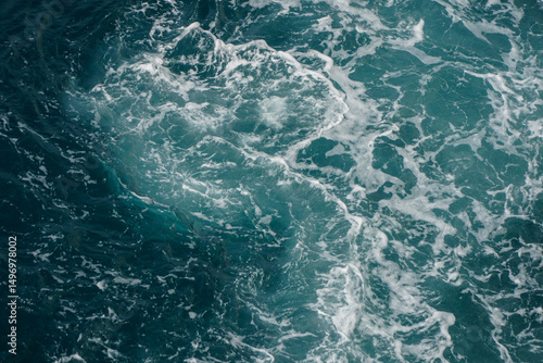 Dynamic Ocean Waves Creating Abstract Patterns in Blue and Teal Water Surface