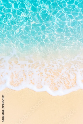 Beach shoreline with turquoise ocean waves washing onto yellow sand viewed from above. Aerial beach image for banner with copy space. Summer vacation and tropical paradise concept.