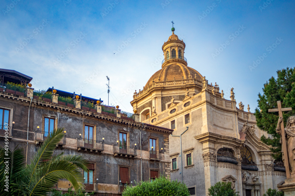 Obraz premium View of the facade of the Abbey Church of Saint Agatha next to a palace in Catania, Sicily, Italy