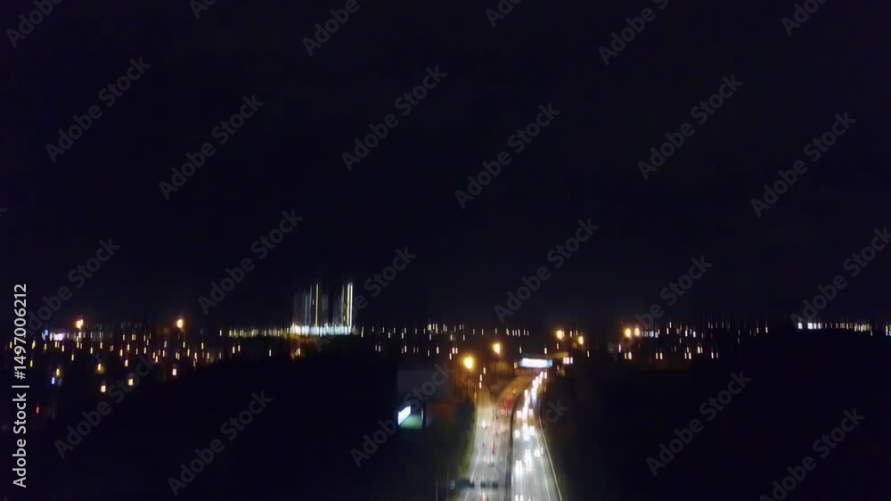 Panning up, drone view of an illuminated highway in Malaysia at night. Panning up, drone view of an illuminated highway in Malaysia at night.