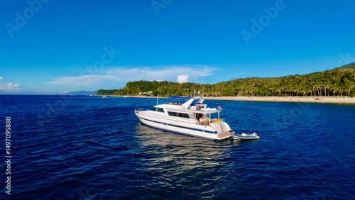Tableau sur toile Aerial view of a motor yacht off the coast of a tropical island