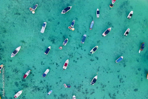 Aerial top view of Sailing and fish boats on turquoise clear tropical water of 