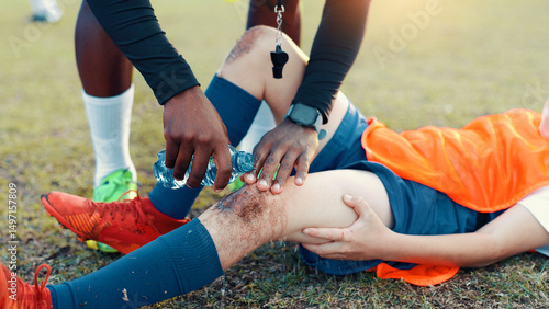 Fotografia Soccer, child and water for injury, knee pain and muscle tension for scrape in sports competition