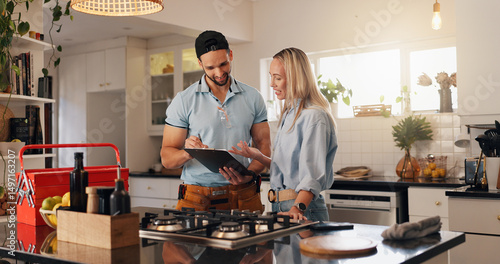 Fotografie Woman, man and plumber with clipboard in home for invoice, report and talk for repair in kitchen