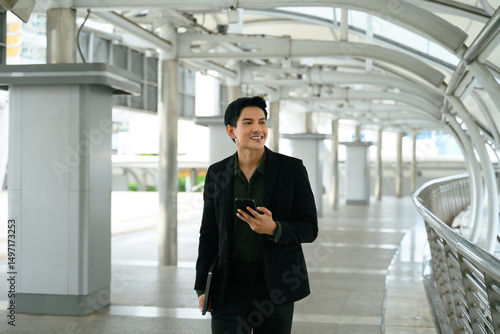 Wallpaper Mural Smiling adult businessman with a phone in hand commuting to work Torontodigital.ca