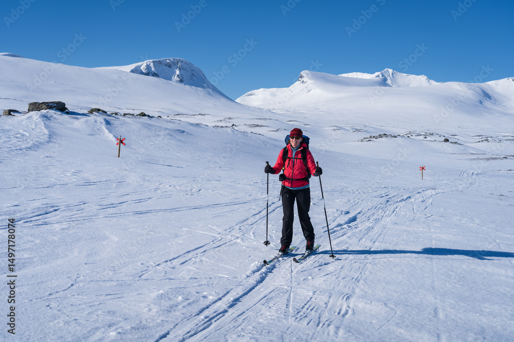 Woman enjoying a beautiful day cross-country skiing the Sylarna mountainrange. Sweden. Woman enjoying a beautiful day cross-country skiing the Sylarna mountainrange. Sweden.