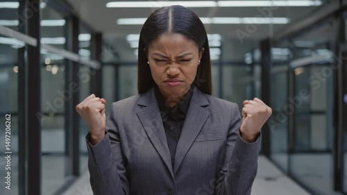 Wallpaper Mural A professional woman, possibly of South Asian descent, with a stern, determined expression, symbolizing strength and resolve in a business context. Ideal for corporate and empowerment themes. Torontodigital.ca