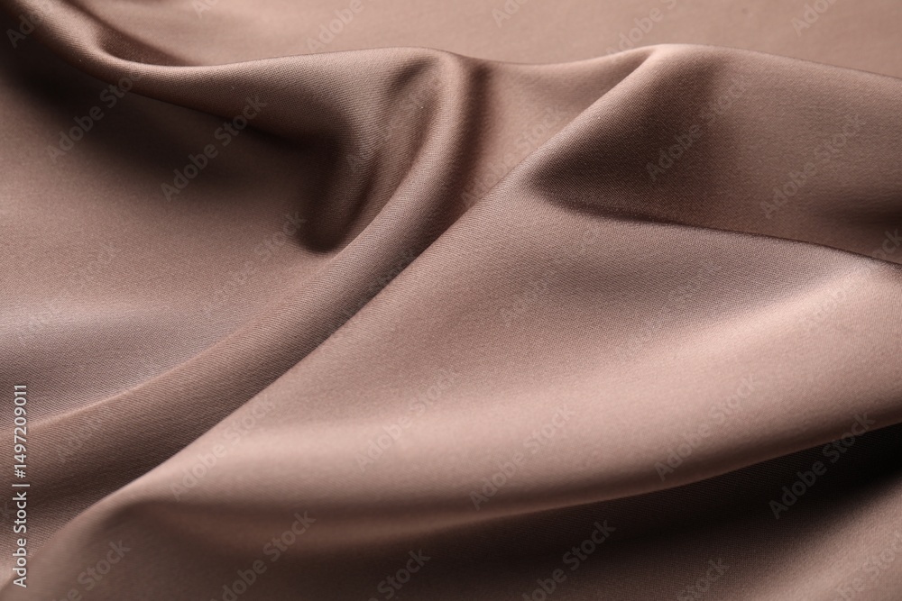 Fototapeta premium Crumpled light brown silk fabric as background, closeup